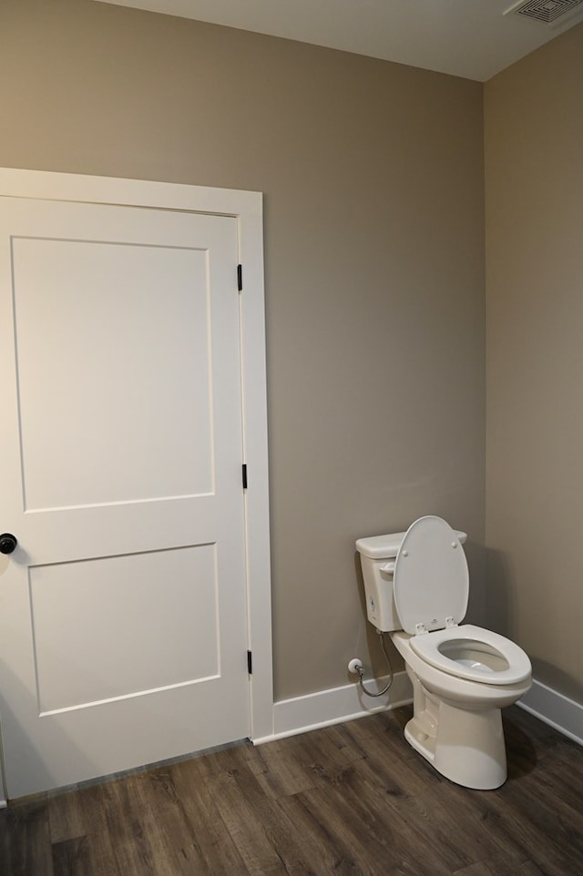 bathroom with toilet and hardwood / wood-style flooring