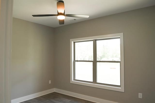 empty room featuring dark hardwood / wood-style flooring and ceiling fan