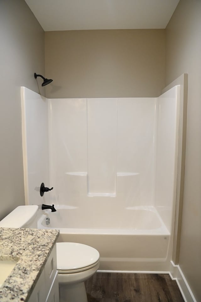 full bathroom with bathtub / shower combination, vanity, toilet, and hardwood / wood-style flooring