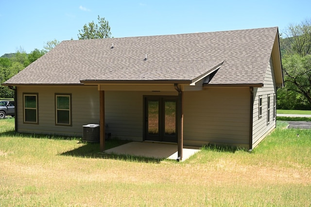 rear view of property featuring central AC