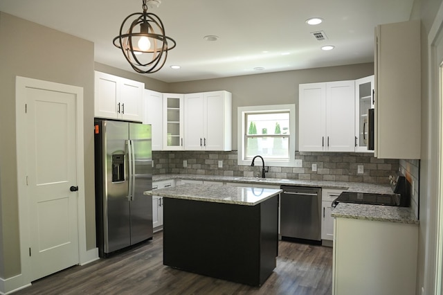 kitchen with a center island, dark hardwood / wood-style floors, stainless steel appliances, and white cabinetry