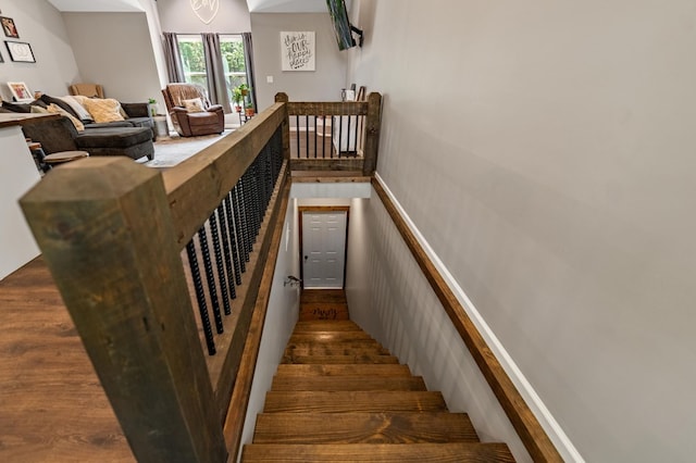 staircase with wood-type flooring