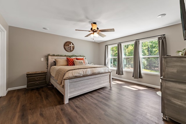 bedroom with dark hardwood / wood-style floors and ceiling fan