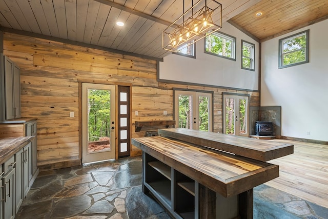 43 Old Federal Rd, Talking Rock, GA 30175 - dining space with a wood stove, wood ceiling, recessed lighting, wooden walls, and dark stone finish floors