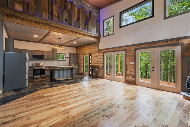 43 Old Federal Rd, Talking Rock, GA 30175 - unfurnished living room featuring french doors, a towering ceiling, hardwood / wood-style floors, wooden ceiling, and wood walls