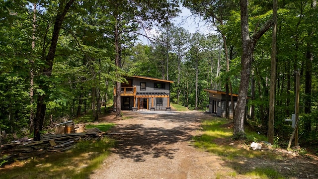 43 Old Federal Rd, Talking Rock, GA 30175 - view of front of home featuring dirt driveway, a garage, a deck, board and batten siding, and a forest view