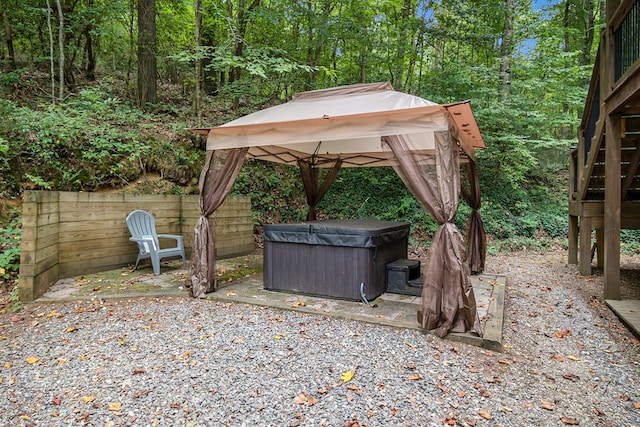 exterior space with a hot tub and a gazebo