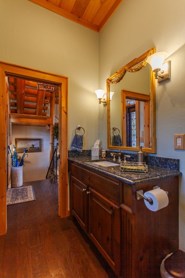 bathroom with hardwood / wood-style floors, vanity, and wooden ceiling