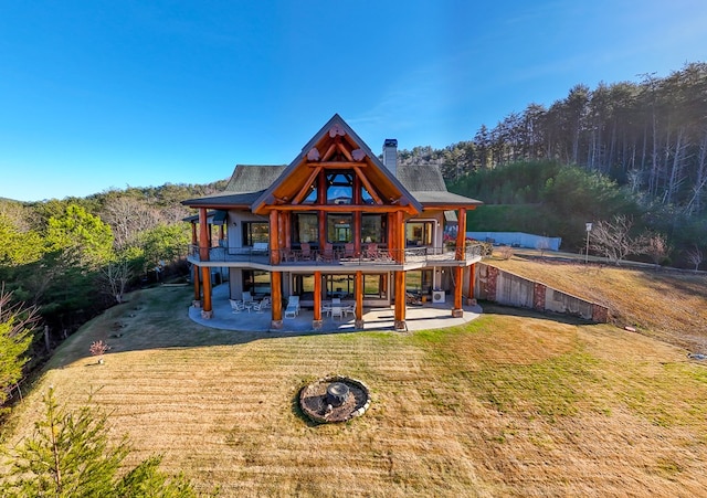 rear view of house with a lawn and a patio area