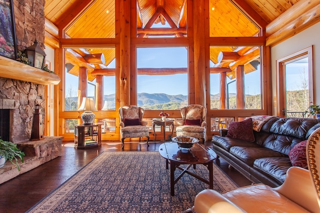 living room with a mountain view, high vaulted ceiling, a wealth of natural light, and wooden ceiling