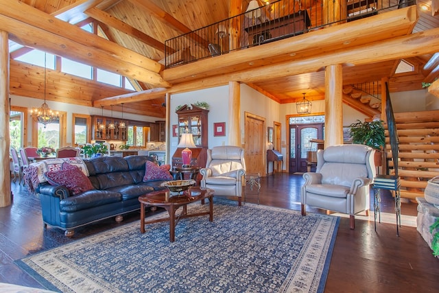 living room featuring dark hardwood / wood-style flooring, rustic walls, beam ceiling, a notable chandelier, and a high ceiling