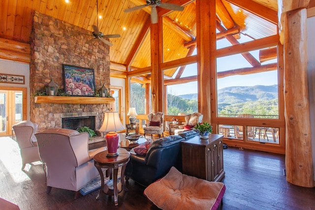 living room featuring a mountain view, a fireplace, high vaulted ceiling, and dark hardwood / wood-style floors