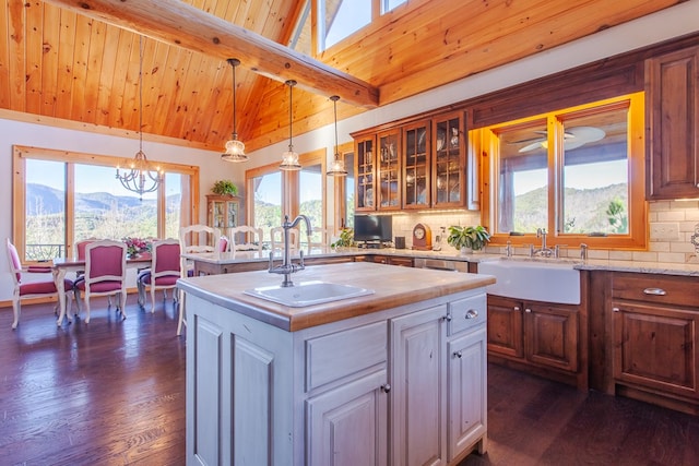 kitchen featuring a mountain view, a kitchen island, and a healthy amount of sunlight