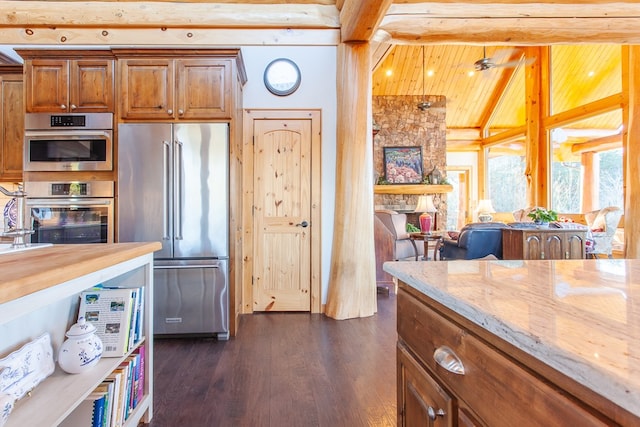 kitchen featuring dark hardwood / wood-style flooring, high end fridge, ceiling fan, wooden ceiling, and vaulted ceiling with beams