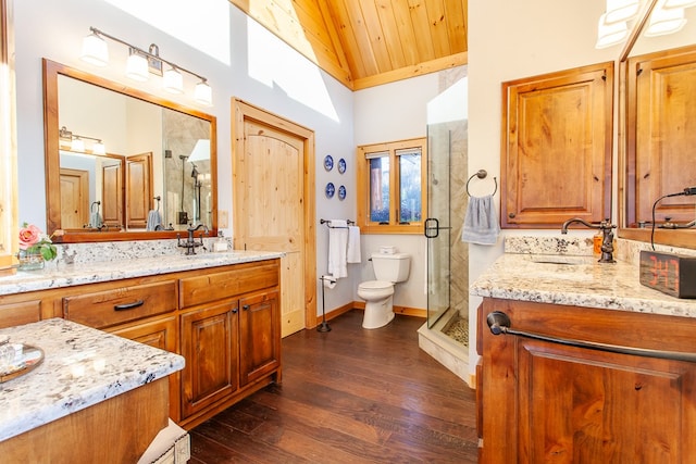 bathroom featuring wooden ceiling, hardwood / wood-style floors, lofted ceiling, toilet, and vanity