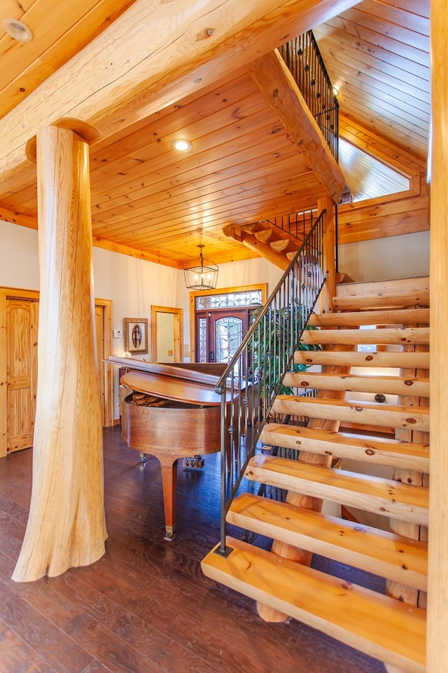 playroom featuring dark hardwood / wood-style flooring, wood ceiling, and an inviting chandelier