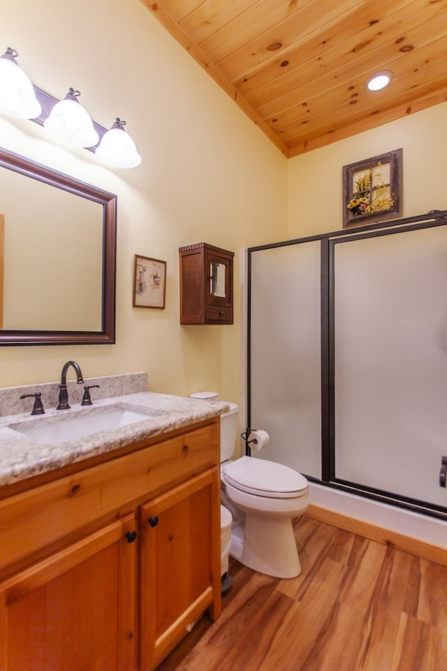 bathroom with wooden ceiling, wood-type flooring, toilet, a shower with door, and vanity