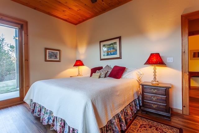 bedroom with access to exterior, dark hardwood / wood-style floors, and wood ceiling