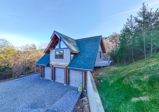 view of front of home with a deck and a garage