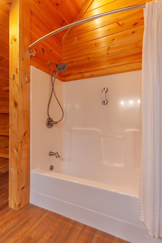 bathroom featuring hardwood / wood-style flooring, lofted ceiling, wooden ceiling, and shower / tub combo