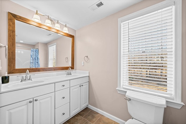 735 Amberton Close, Suwanee, GA 30024 - bathroom with double vanity, baseboards, toilet, and tile patterned floors
