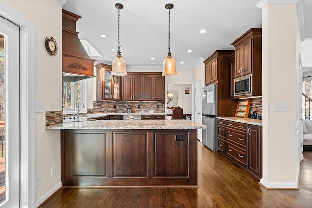 735 Amberton Close, Suwanee, GA 30024 - kitchen featuring appliances with stainless steel finishes, a peninsula, backsplash, dark wood finished floors, and hanging light fixtures