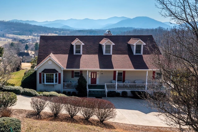 cape cod house featuring a mountain view and a porch