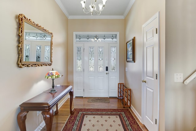 foyer with a healthy amount of sunlight, hardwood / wood-style flooring, and crown molding