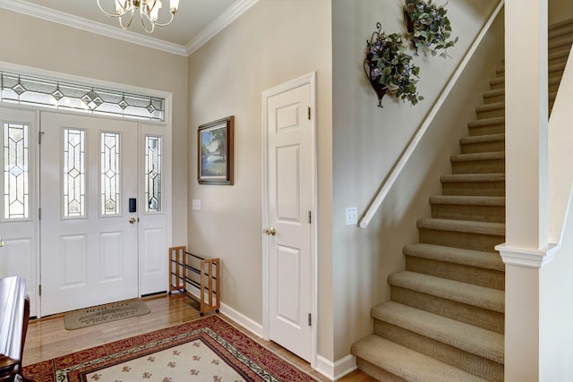 entrance foyer featuring a chandelier, hardwood / wood-style flooring, and ornamental molding