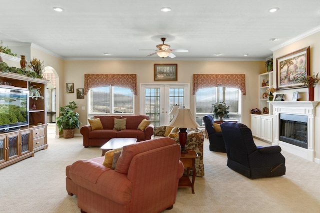 living room featuring light colored carpet, crown molding, and ceiling fan