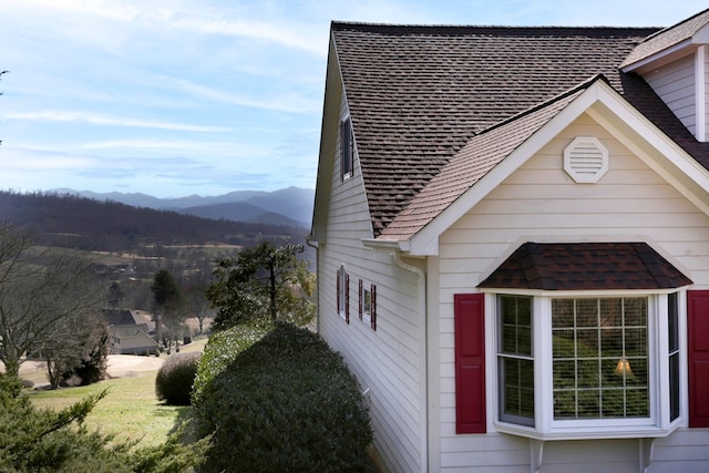 view of property exterior with a mountain view