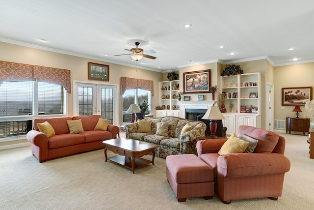 carpeted living room featuring ceiling fan, french doors, and crown molding