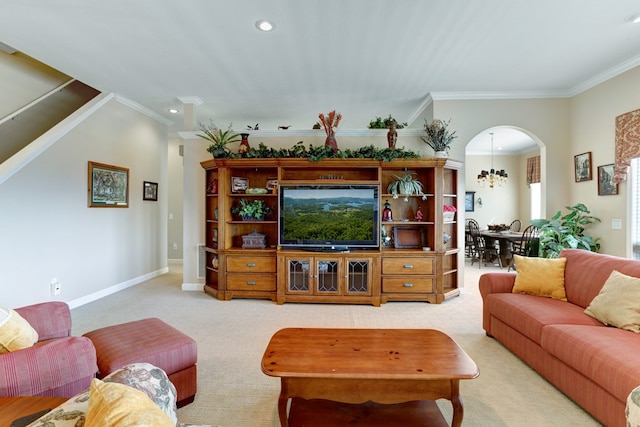 carpeted living room featuring ornamental molding and a notable chandelier