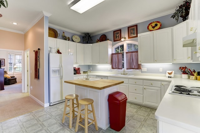 kitchen featuring light colored carpet, white cabinetry, a center island, and white fridge with ice dispenser