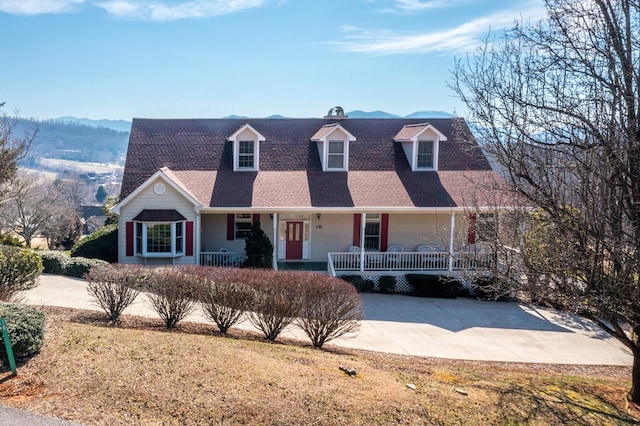 cape cod-style house with a mountain view and covered porch