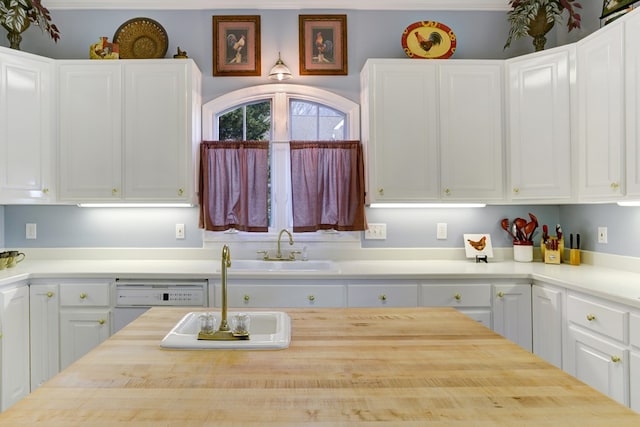 kitchen featuring sink, crown molding, and white cabinets