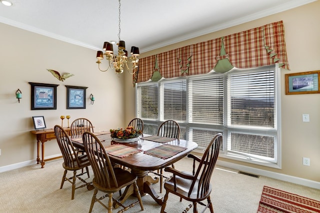 carpeted dining area with ornamental molding, a healthy amount of sunlight, and a chandelier