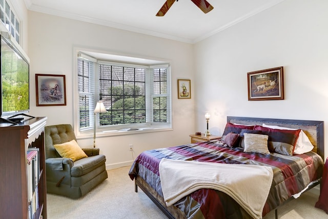 bedroom with carpet flooring, ceiling fan, and crown molding