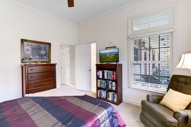 carpeted bedroom with ornamental molding and ceiling fan