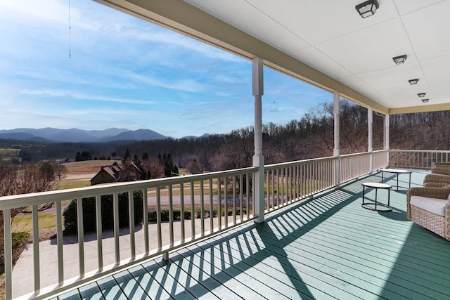 wooden deck with a mountain view