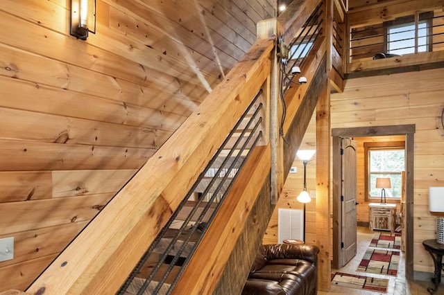 interior space featuring wooden ceiling, wood walls, and high vaulted ceiling