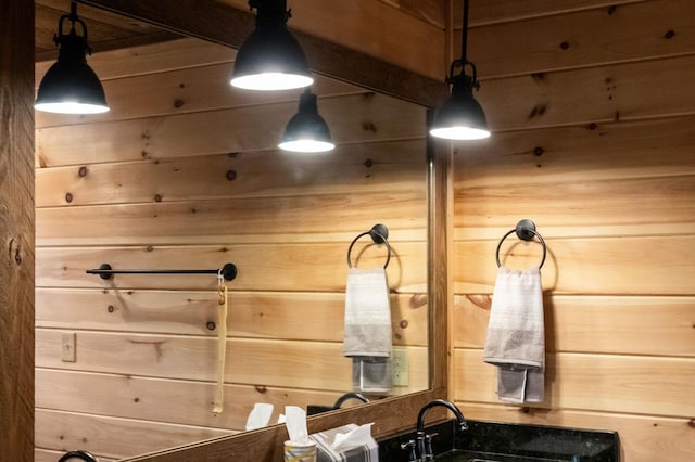 interior details featuring wood walls and vanity