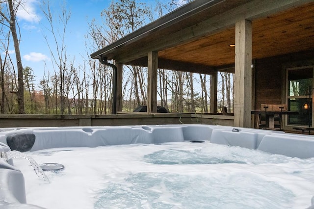 snow covered patio with a hot tub