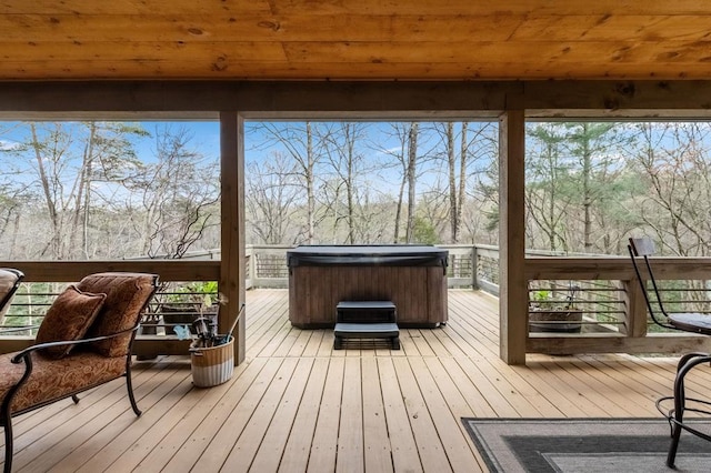 wooden deck featuring a hot tub