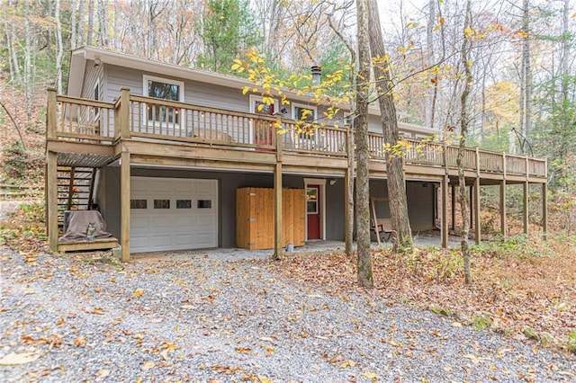 view of front of house featuring a garage and a deck