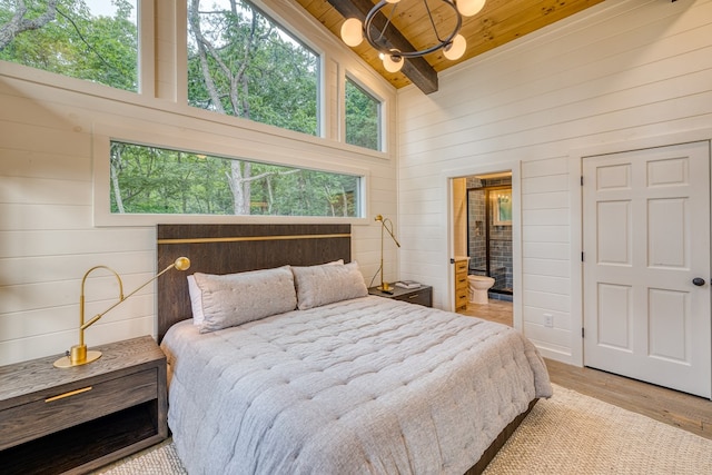 bedroom featuring ensuite bath, wood walls, wooden ceiling, wood finished floors, and beamed ceiling