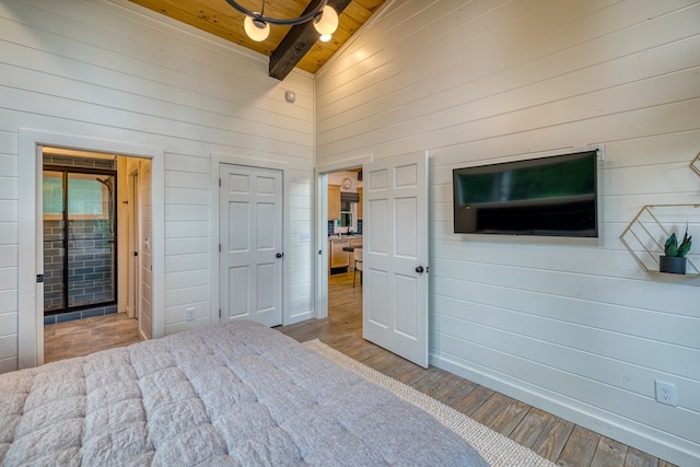 bedroom with high vaulted ceiling, wood walls, wood finished floors, beamed ceiling, and wood ceiling