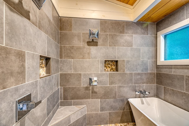 bathroom with wooden ceiling, a freestanding tub, and a tile shower