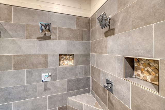 interior details featuring tiled shower