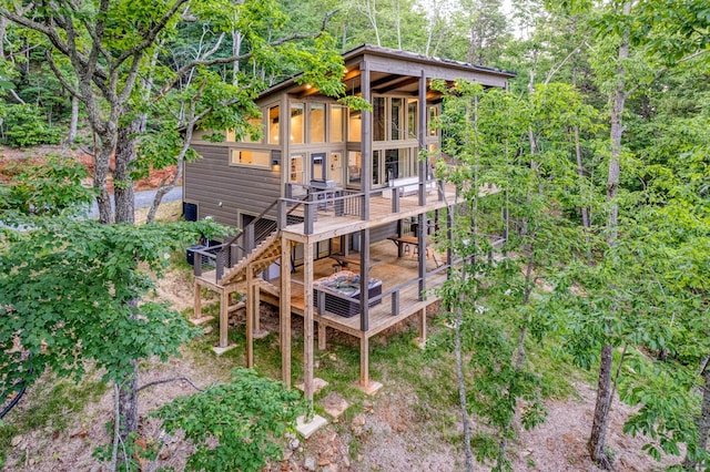 exterior space featuring stairs and a wooden deck